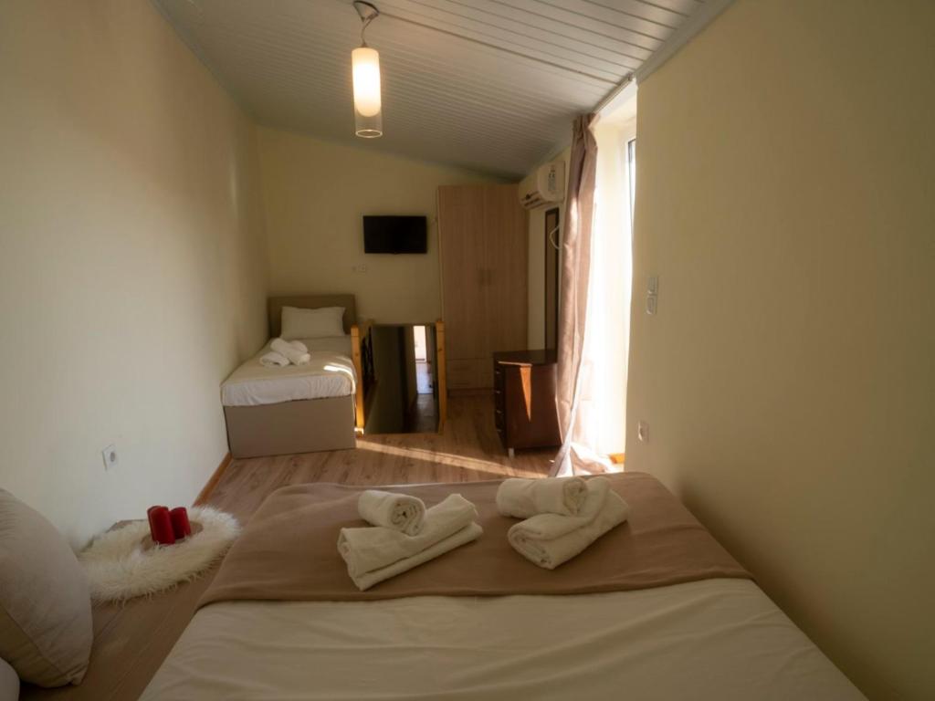 a room with a bed with towels on it at Manto Apartments Lefkada in Évyiros