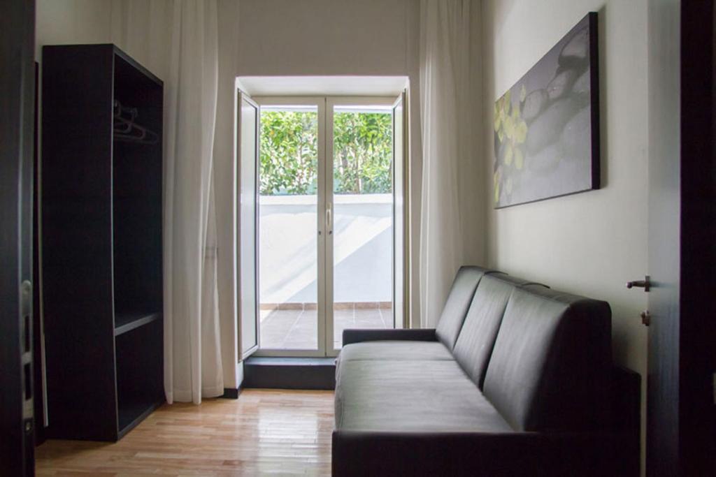 ein Wohnzimmer mit einem Sofa und einem Fenster in der Unterkunft Il Paradiso di Dante in Neapel