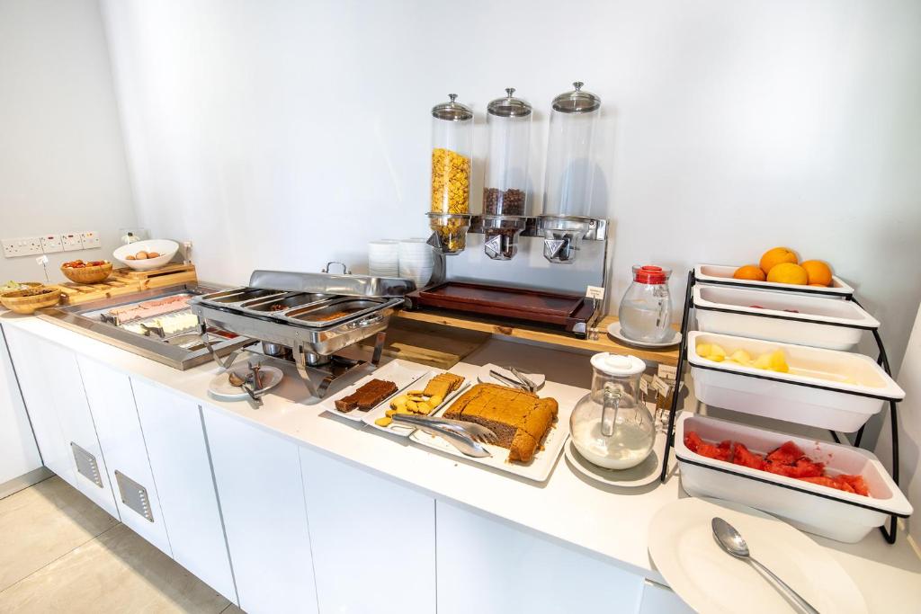 a kitchen with a counter with food on it at Bellini Hotel in Ayia Napa