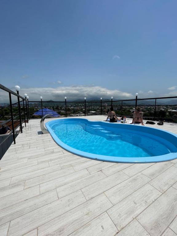 a swimming pool on the roof of a house at Hotel Royal Georgia in Batumi