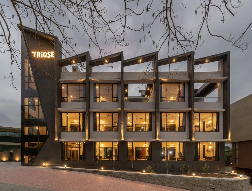 an office building with a lit up sign on it at Triose Boutique Hotel Lonavala in Lonavala