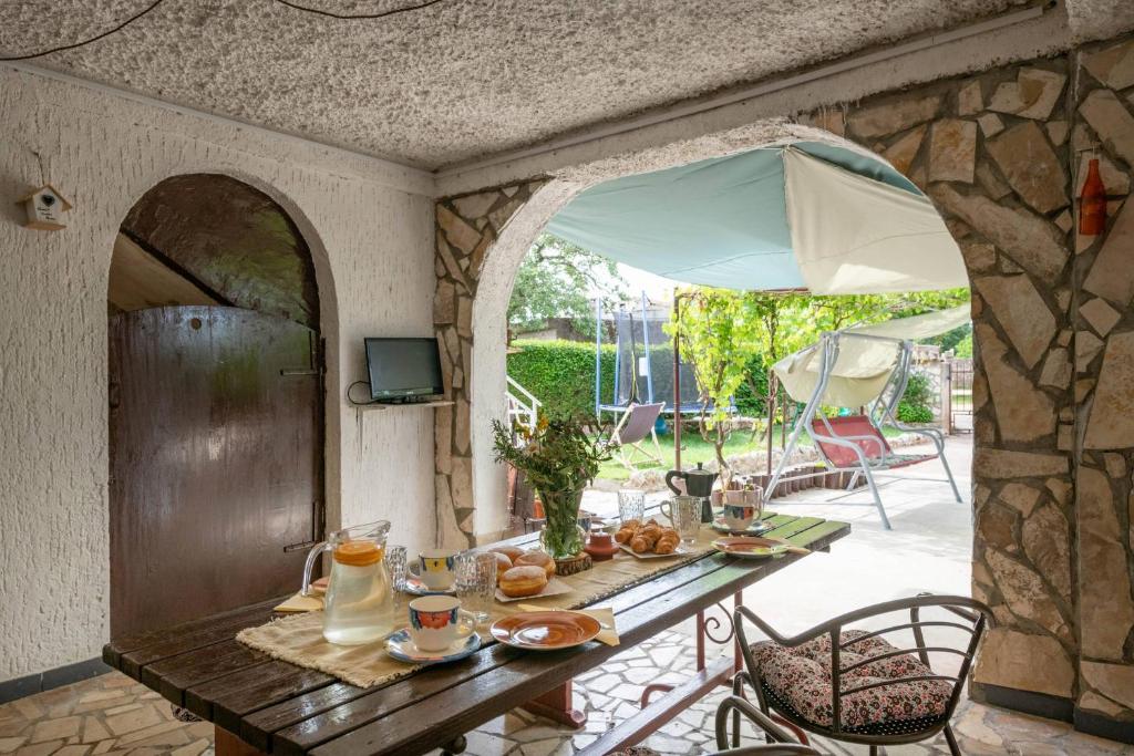 a table with food on it in a patio at Holiday house Ruba in Marčana