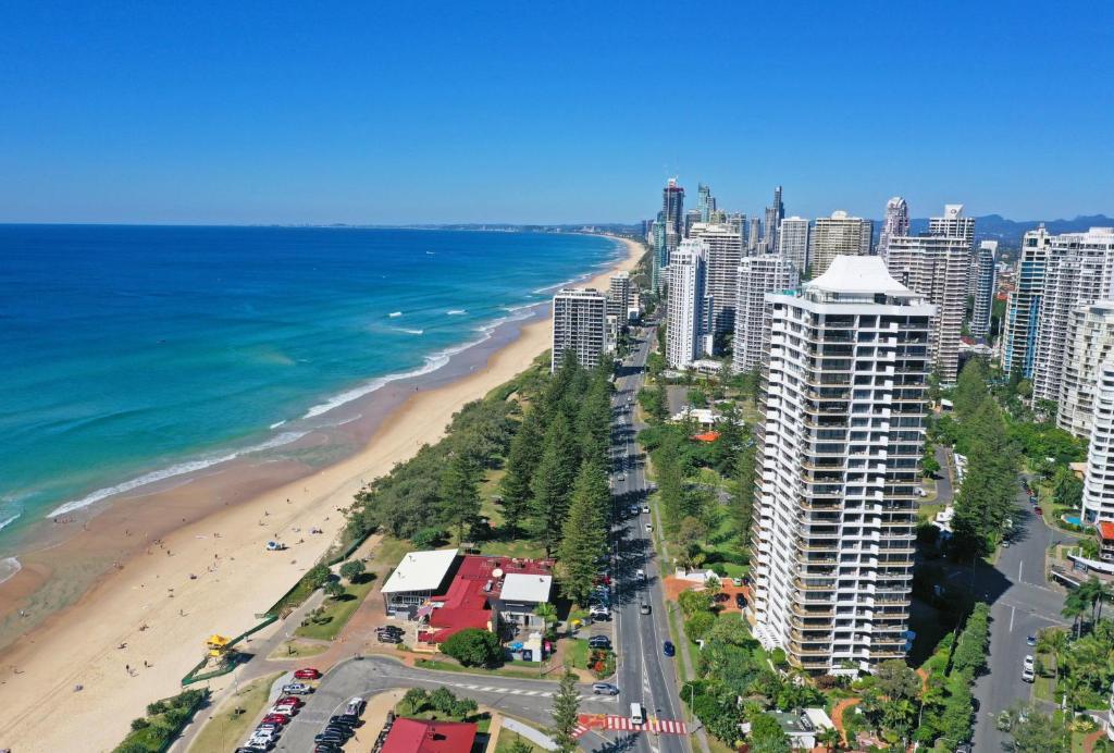 an aerial view of a beach and buildings and the ocean at De Ville Apartments in Gold Coast