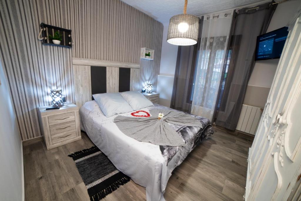a bedroom with a bed with an umbrella on it at APARTAMENTO LA VEGUILLA in Alhama de Aragón