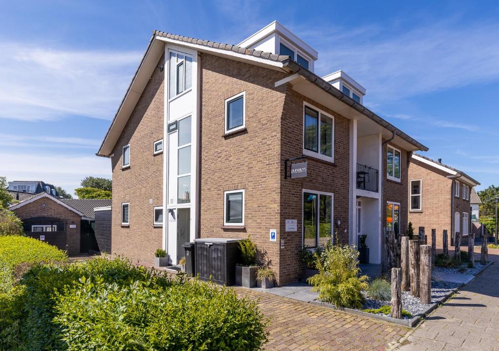 a large brick building with a large window at B&B Duinhuys in Domburg