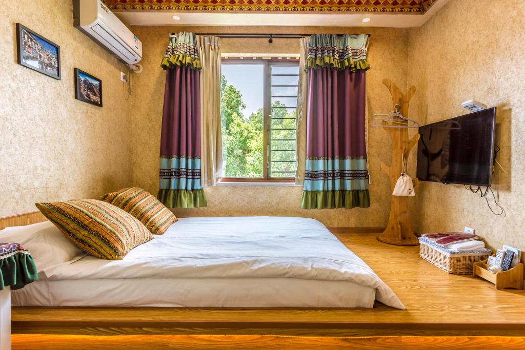 Postel nebo postele na pokoji v ubytování Hangzhou Citynest Music B&B
