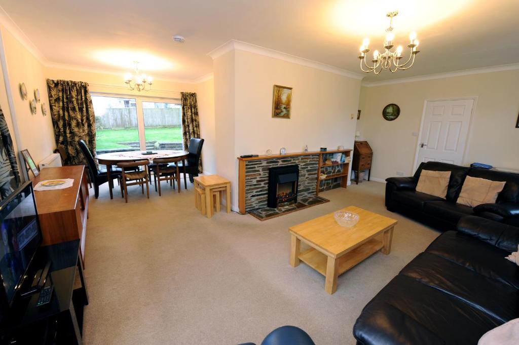 a living room with a couch and a fireplace at Glan Heulog - Near to Beach, Pet Friendly in Saundersfoot