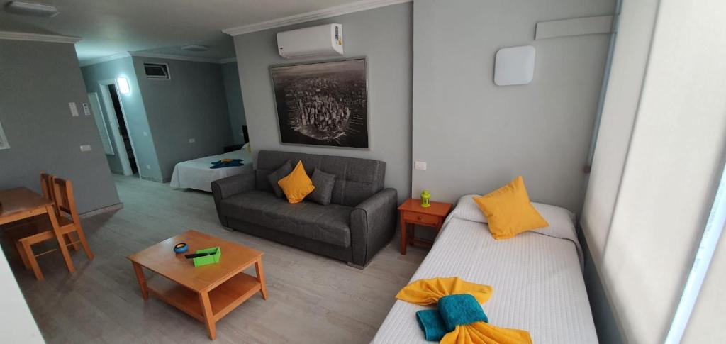 a small living room with a couch and a table at Green Park in San Miguel de Abona