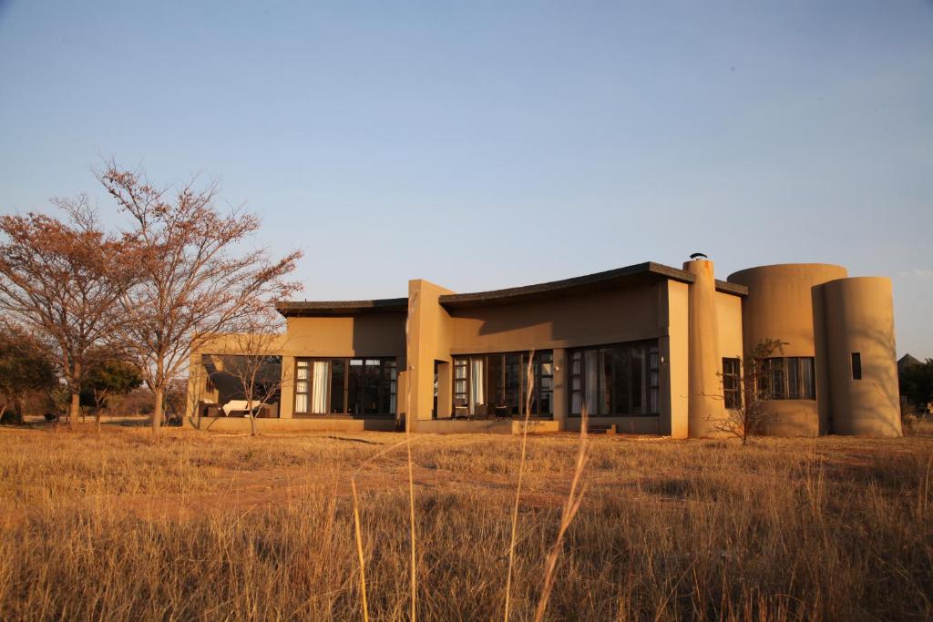 a building with three silos on it in a field at Legend Golf and Safari Resort in Sterkrivier
