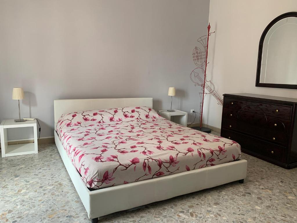 a bedroom with a bed and a dresser and a mirror at Sorrento Soul in Sorrento