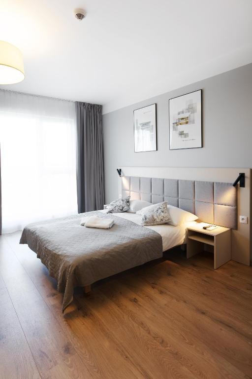 Posteľ alebo postele v izbe v ubytovaní Wolska Residence I
