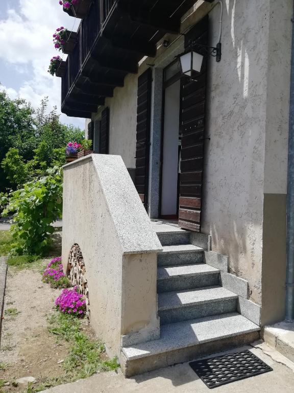 a set of stairs leading to a building with flowers at Casa Lena in Ledro