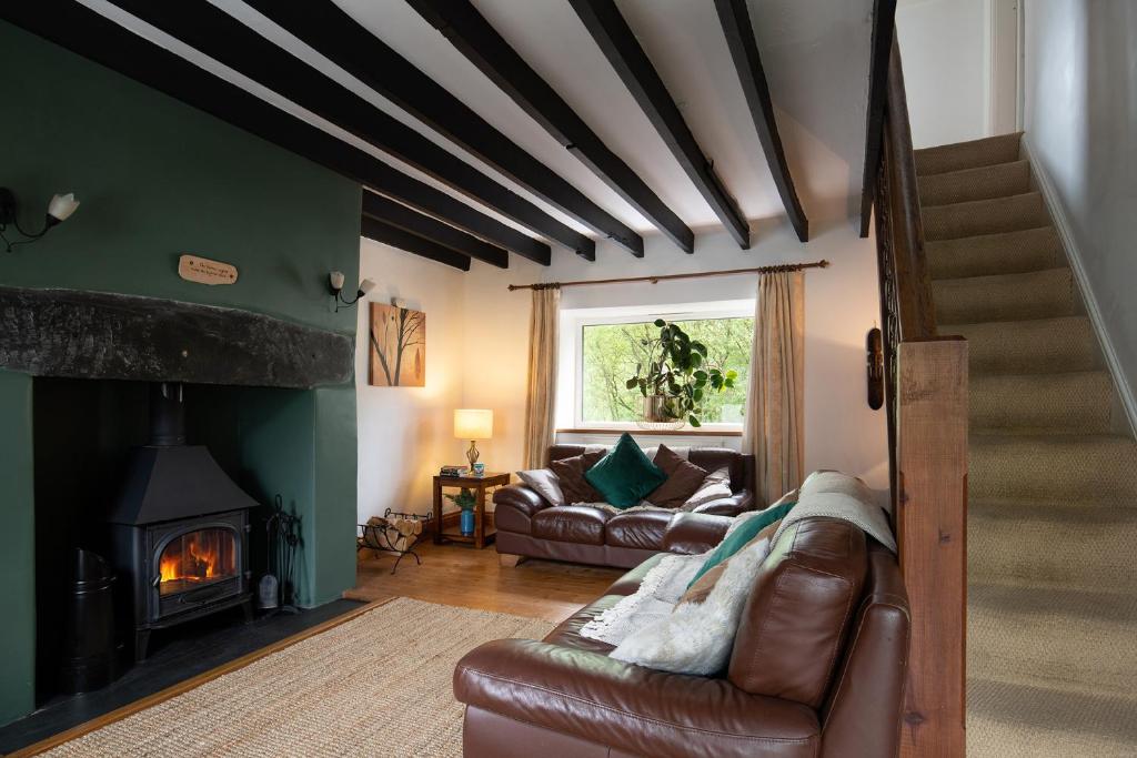 a living room with a couch and a fireplace at Finest Retreats - Bron Elan in Dolwyddelan