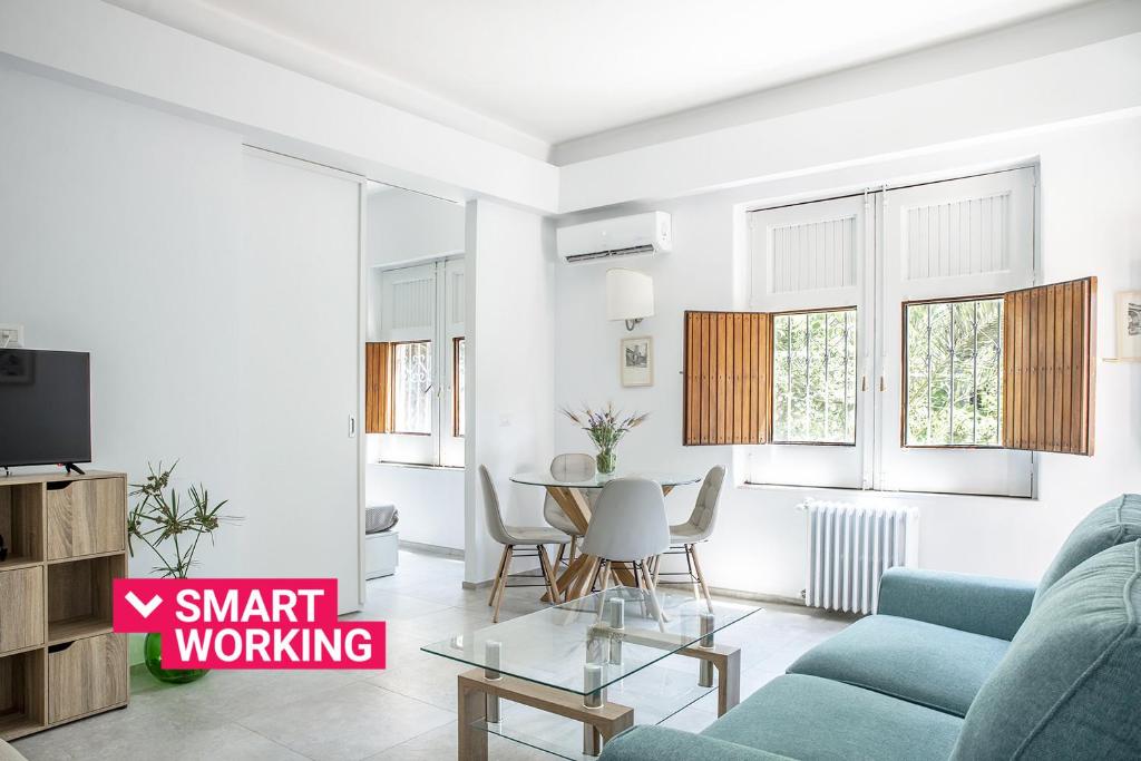 a living room with a blue couch and a table at Euphorbia Apartments by Wonderful Italy in Catania