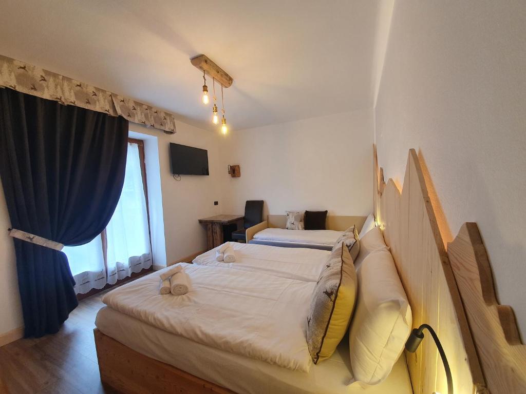 Postel nebo postele na pokoji v ubytování Hotel Pezzotti