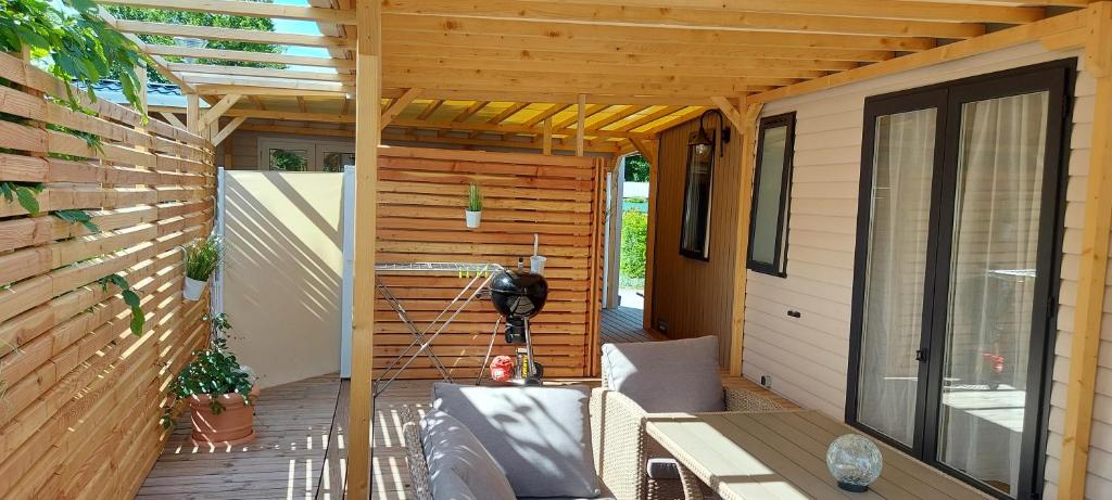 an outdoor patio with a wooden pergola at PP-Camping Wallersee in Seekirchen am Wallersee