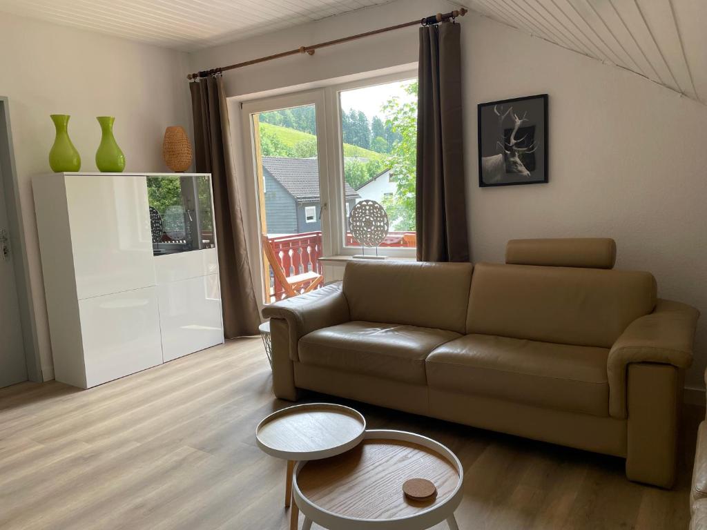a living room with a couch and a table at Appartement 5 Willingen in Willingen