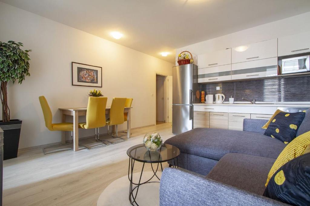 uma sala de estar com um sofá, uma mesa e uma cozinha em Apartman Seka em Njivice