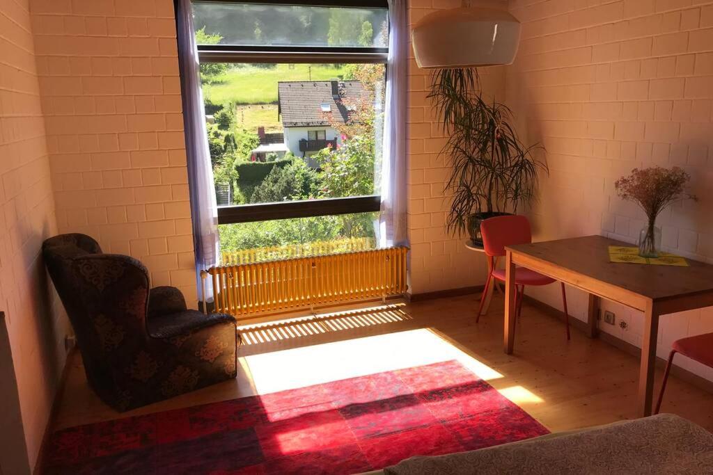 a room with a window and a table and a chair at Exklusive Ferienwohnung MIRO 25 m² in ruhiger Lage in Heidelberg