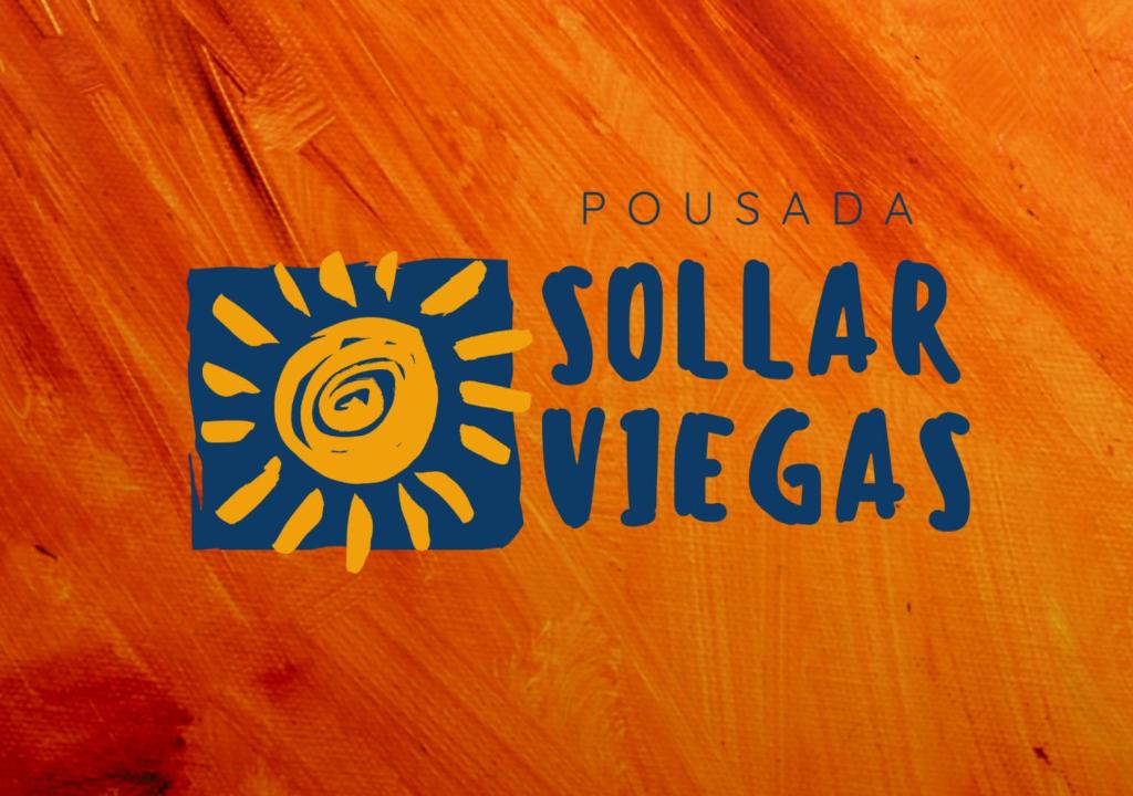 a sign that reads pulsada solar unlegas on an orange wall at Pousada Sollar Viegas in Peruíbe
