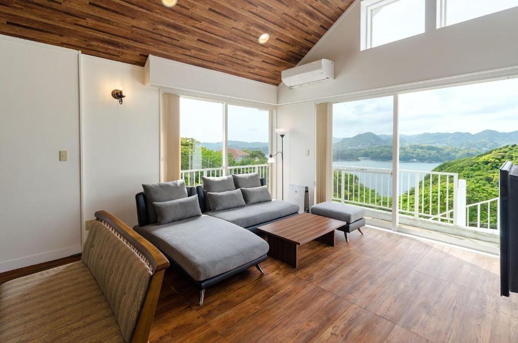a living room with a couch and a table at Bay Coast Villa Susaki - Vacation STAY 45723v in Shimoda