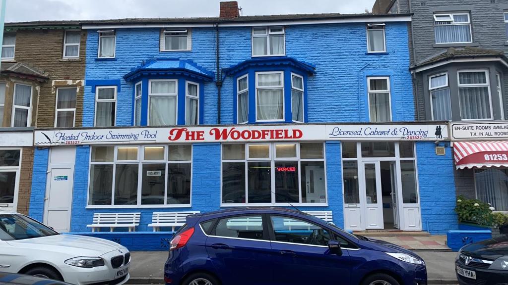 a blue building with a car parked in front of it at The Woodfield Hotel in Blackpool