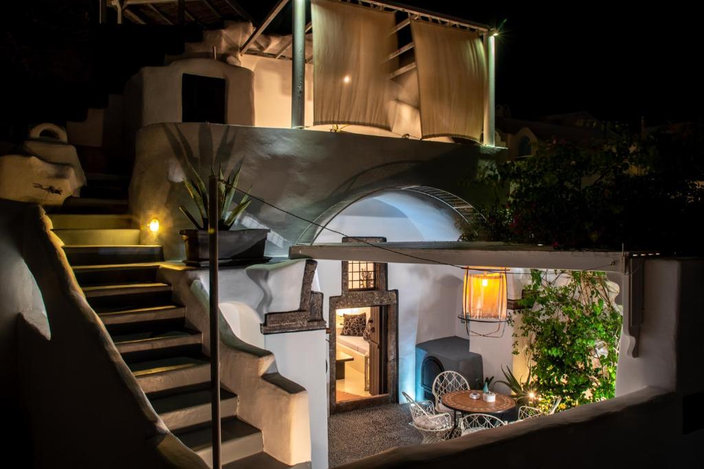 a staircase leading up to a house at night at Villa Orpheus Santorini in Megalokhori