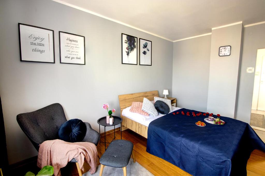 1 dormitorio con 1 cama y 1 silla en Apartament Cicha, en Rzeszów
