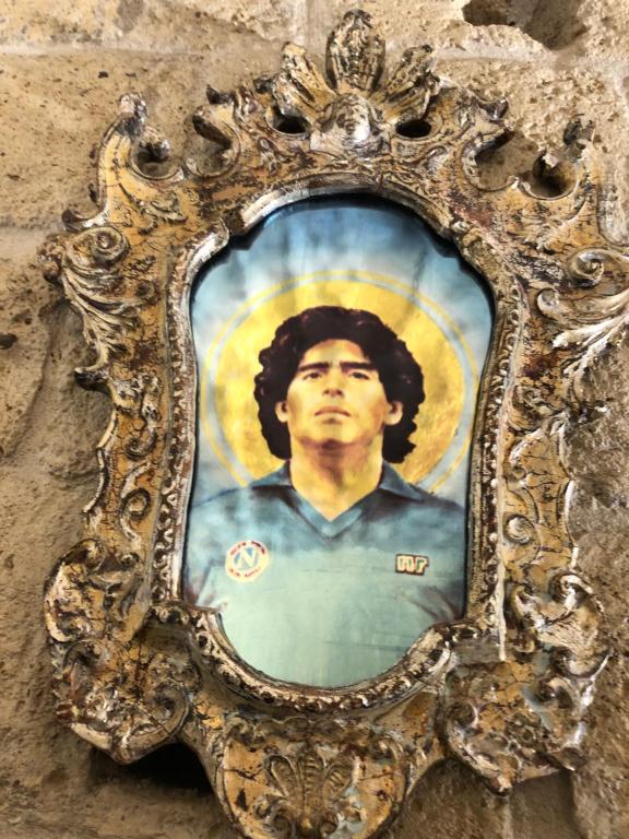 Ein Bild eines Mannes an der Wand in der Unterkunft Donna Margherita Appartamento in Neapel