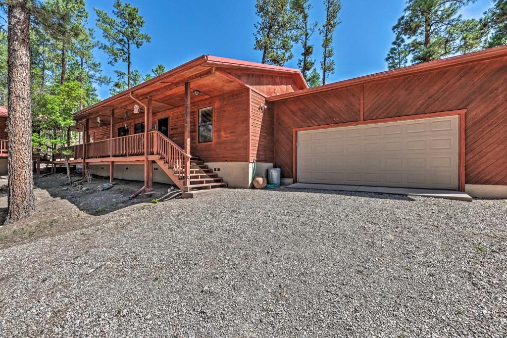 a house with a large driveway and a garage at Wooded Ruidoso Hideaway with Deck Ski, Hike and Golf! in Ruidoso