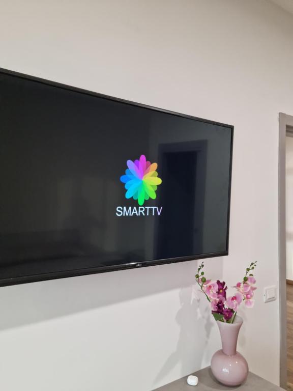 Televízia a/alebo spoločenská miestnosť v ubytovaní Qvattro stagioni panoramic suites