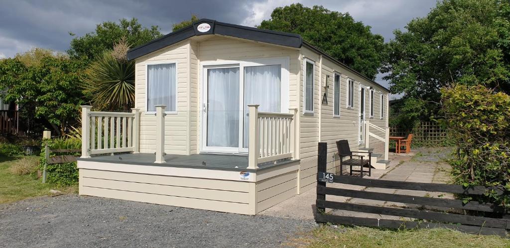 a small house with a porch and a bench at Port Haverigg Marina Village in Millom