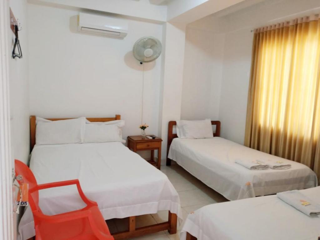 מיטה או מיטות בחדר ב-Hotel Comercial Neiva