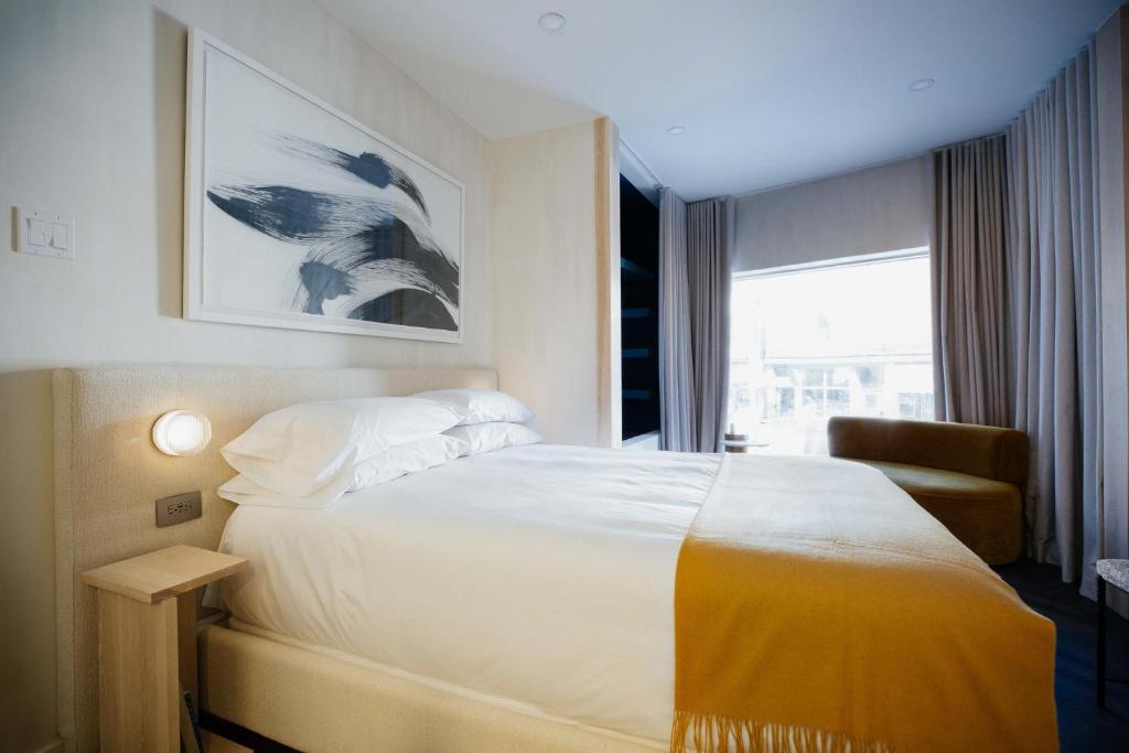 a hotel room with a bed and a window at Ode in Toronto