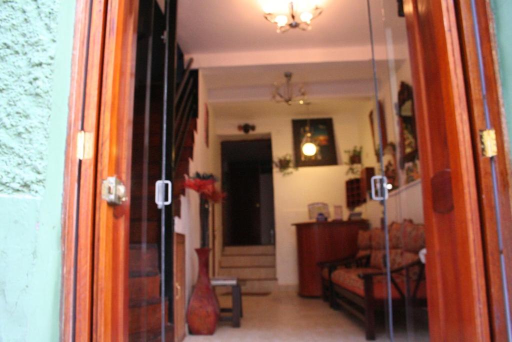 a hallway with a living room with a couch at Hostal El Auqui in Cusco