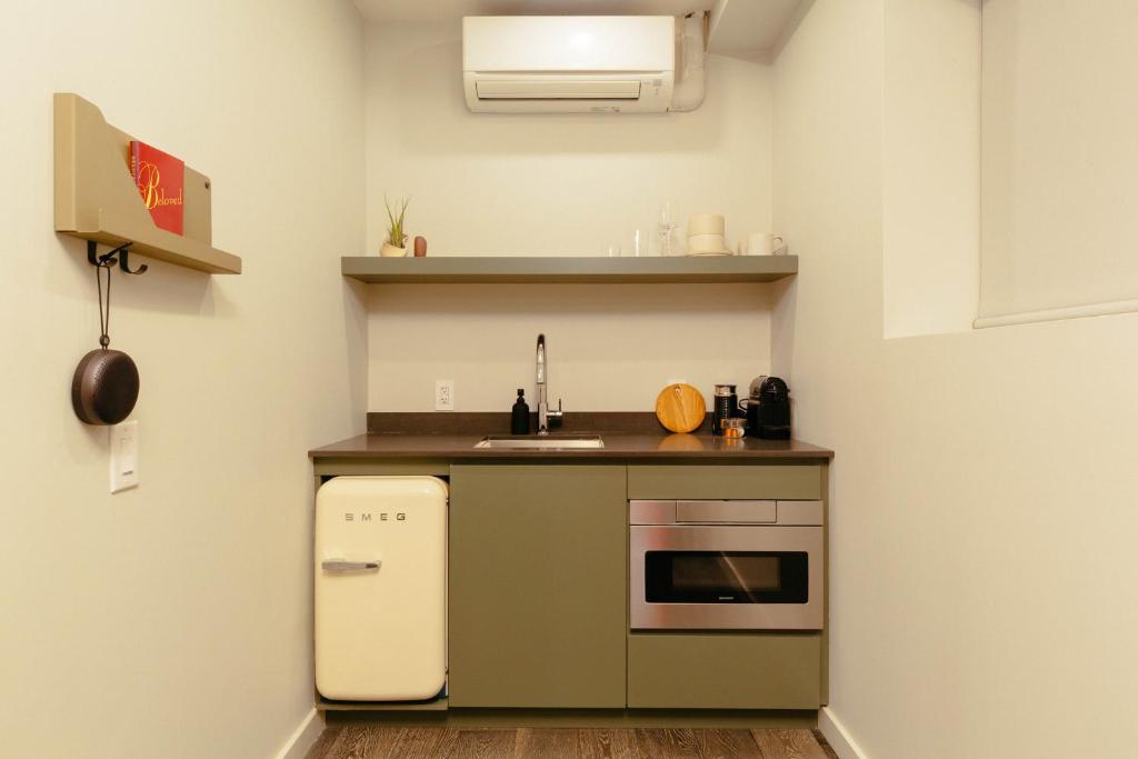 a small kitchen with a sink and a stove at Ode in Toronto
