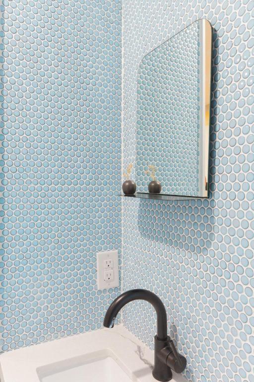 a bathroom with a sink and a mirror at Ode in Toronto