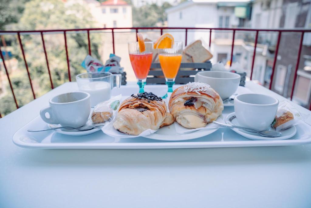 a tray of pastries on a table with cups and drinks at La collina di Capodimonte in Naples