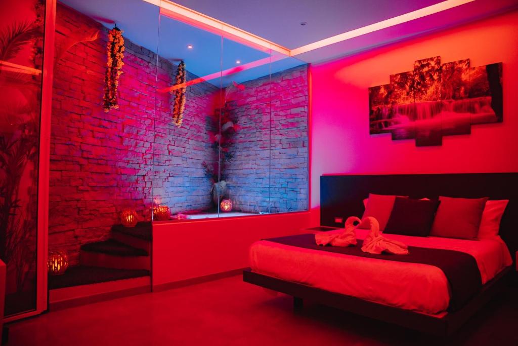 a red room with two beds and a brick wall at La collina di Capodimonte in Naples