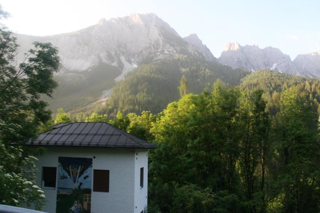 a building with a view of a mountain at Dolomiti house in Cibiana
