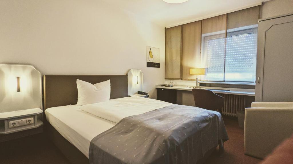 Postel nebo postele na pokoji v ubytování Hotel Rotes Ross
