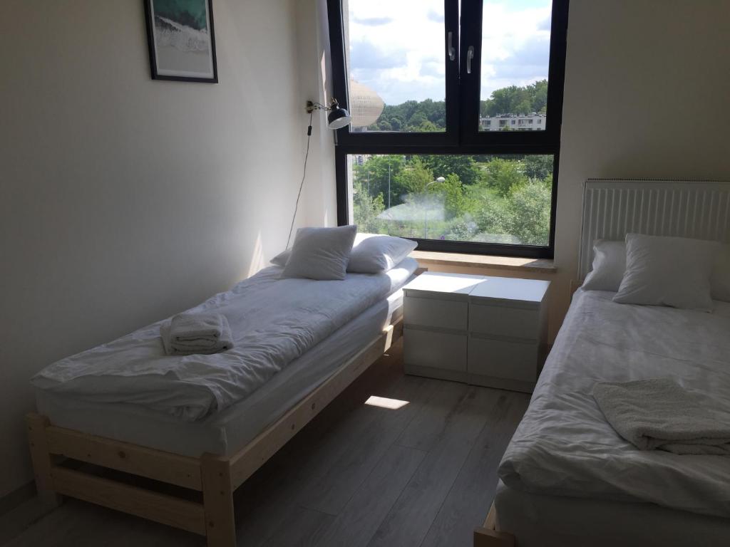 Posteľ alebo postele v izbe v ubytovaní Apartament Kraków Arena No. 100