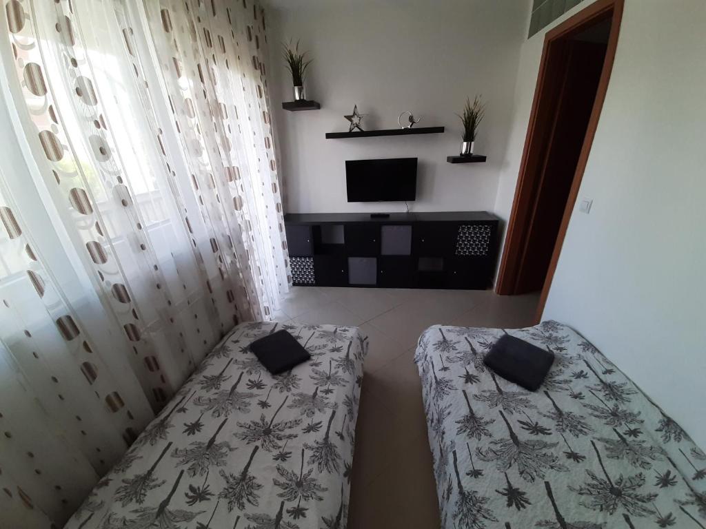Posteľ alebo postele v izbe v ubytovaní Promenade Apartman