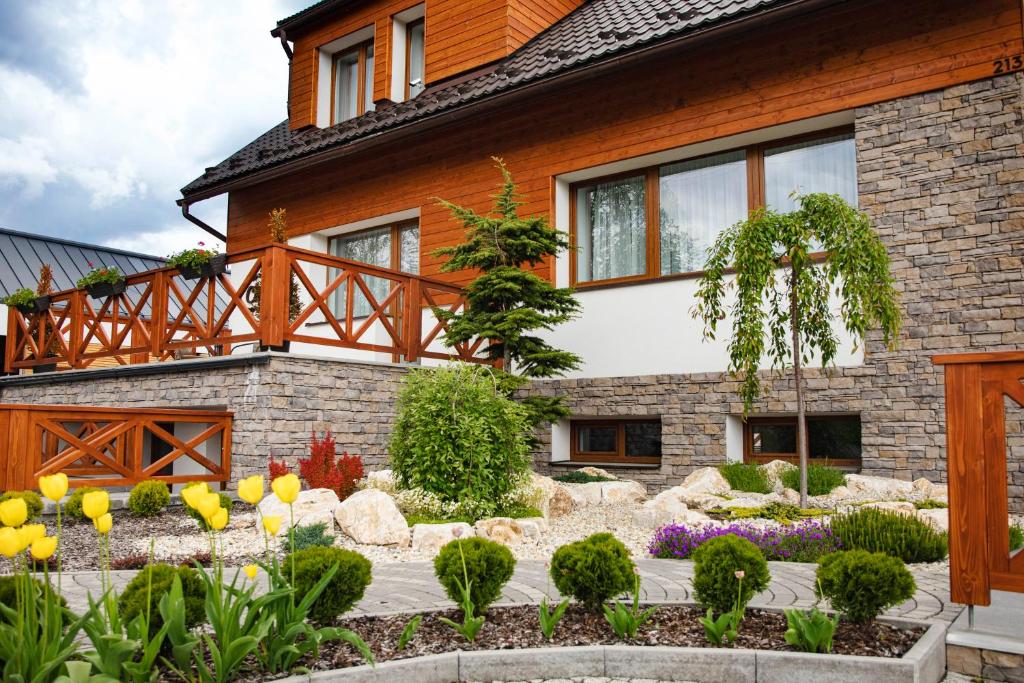 a house with a garden in front of it at Chalet Nova Lesna Mountain View in Nová Lesná