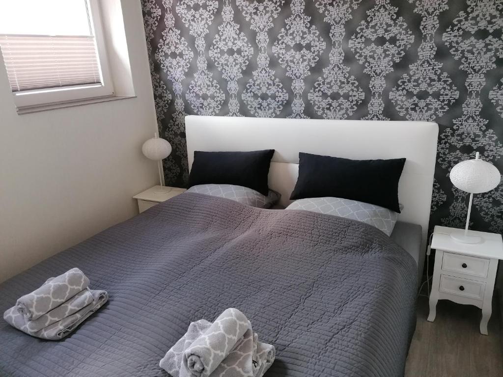 a bedroom with a bed with two pillows on it at Central Loft Apartment in Ueckermünde