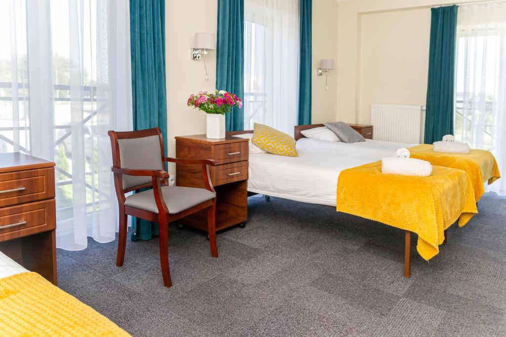 Posteľ alebo postele v izbe v ubytovaní Hotel Przy Solankach