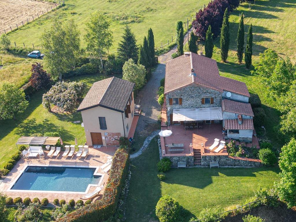 an aerial view of a house with a swimming pool at I Ginepri exclusive CountryHouse, 15pax, private pool, Aulla in Serricciolo