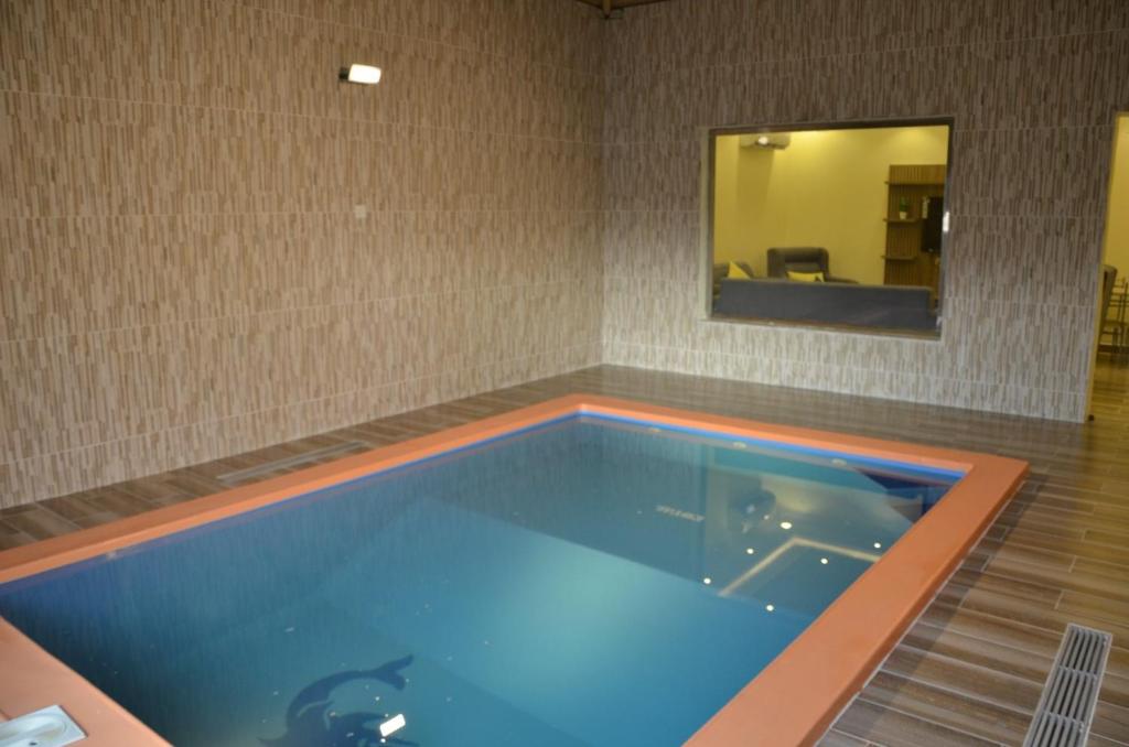 a large swimming pool in a room with a mirror at Marka resort ماركاريزورت in Abha