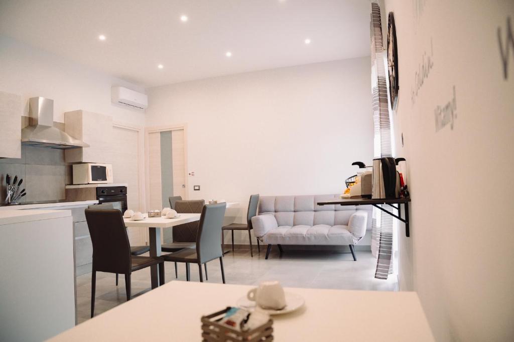 a kitchen and living room with a table and chairs at La collina di Capodimonte in Naples