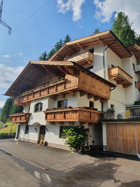 a building with wooden balconies on the side of it at Gästehaus Flörl 1 in Gerlosberg